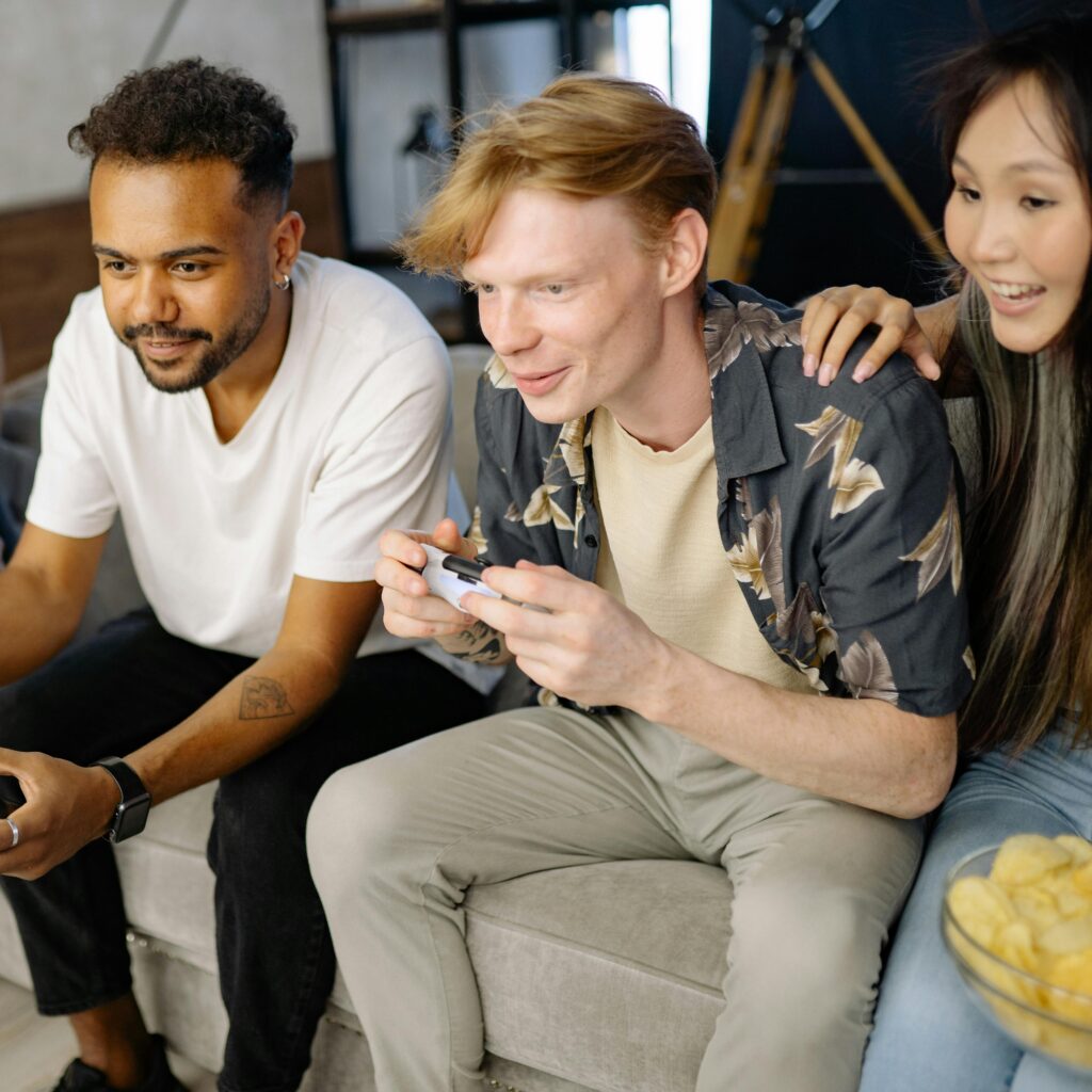 Close-knit group of friends immersed in a video game session at home, showcasing diversity and leisure.