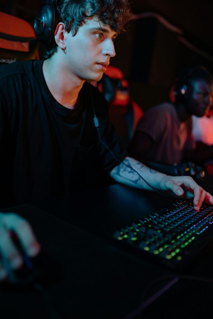 Young man deeply engrossed in a video game, showcasing competitive gaming atmosphere.