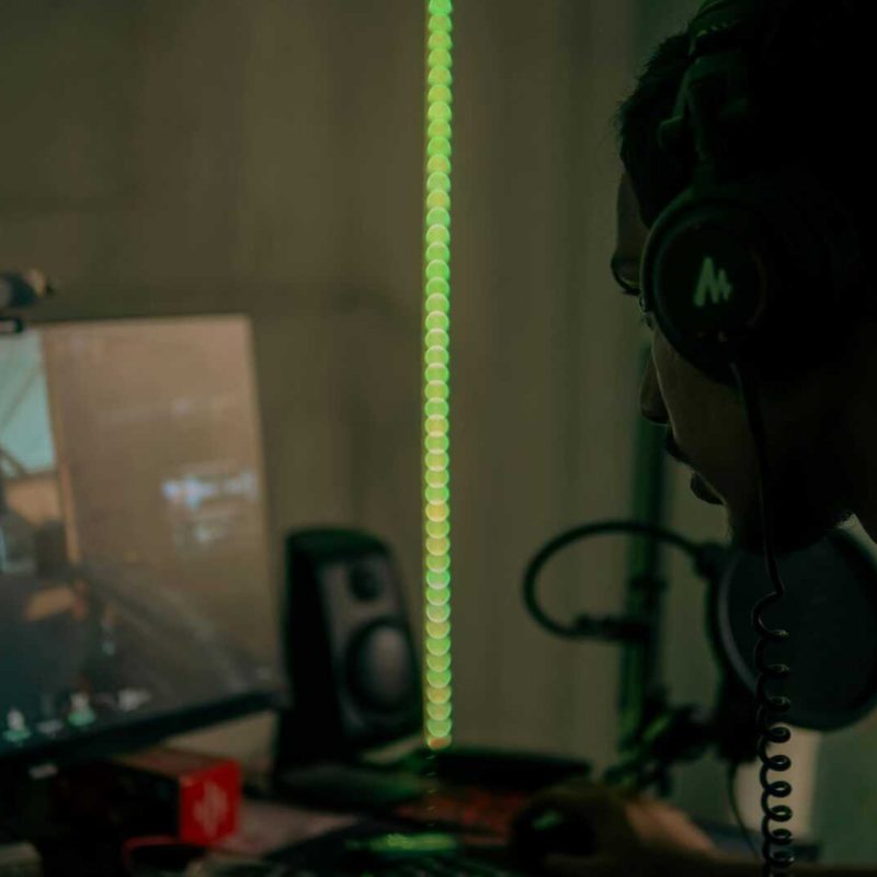 pexels-photo-12832570-12832570 Focused gamer with headset playing a video game on a desktop computer indoors.